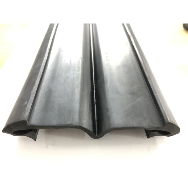 M-shaped rubber profile for rail-type expansion joints